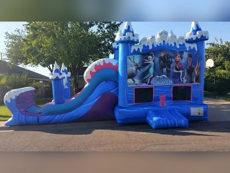 Blue snow-capped castle bounce house with an attached slide