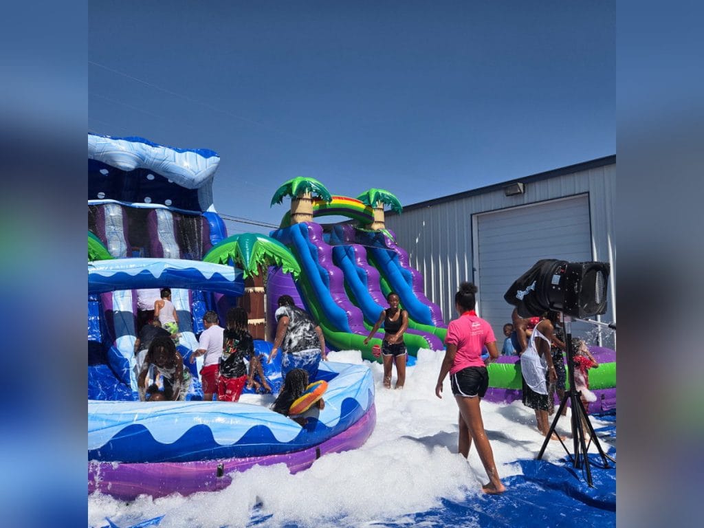 Foam cannon running beside tropical water slides at a foam party, rental in Midland, TX
